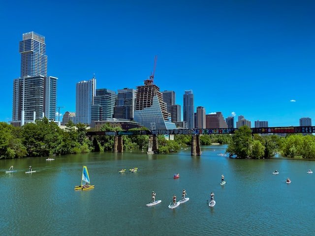People riding a paddle boat in Lady Bird Lake | Spyglass Realty